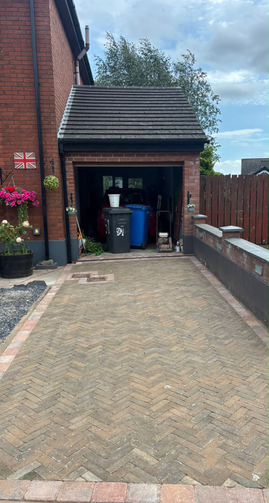 Herringbone block paved driveway leading to garage