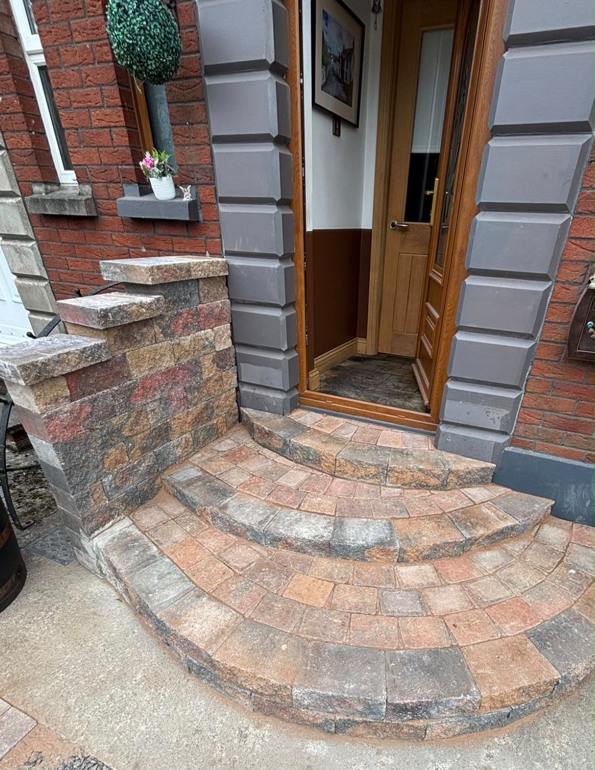 Curved block paved entrance steps with feature pillar